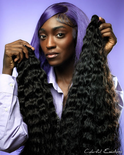 Model holding JMB luxury hair bundles